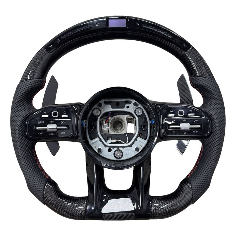 Carbon-pattern steering wheel for Mercedes-AMG with an LED top display, black perforated grips and red stitching