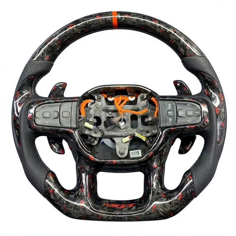 Forged carbon-pattern steering wheel for the Ram 1500 TRX with an orange top marker and black perforated grips