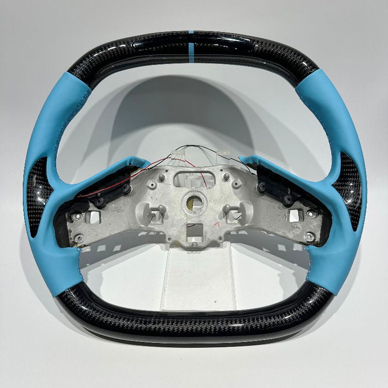 Carbon-pattern steering wheel for the Corvette C8 with light blue leather grips